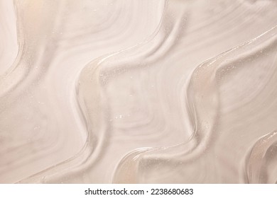 Cosmetic texture beige butter oil or vaseline smudge background