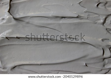Cosmetic texture of gray cream. Cellulite dirt. Lotion, moisturizer, skin care product smear.