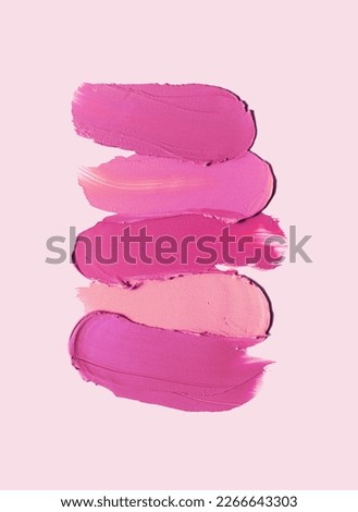 Cosmetic texture smudge fuchsia liquid lipstick. Swatches isolated on pink