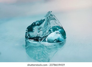 Cosmetic transparent gel with hyaluronic acid with bubbles on a blue background Moisturizing collagen gel with snail mucus for radiant skin on a blue background