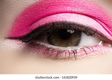 Cosmetics And Beauty Care. Macro Close-up Of Beautiful Green Female Eye With Bright Fashion Runway Make-up. Pink Eyeshadows And Black Eyeliner