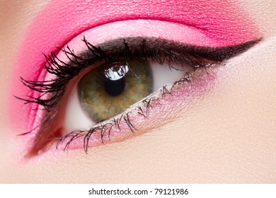 Cosmetics And Beauty Care. Macro Close-up Of Beautiful Green Female Eye With Bright Fashion Runway Make-up. Pink Eyeshadows And Black Eyeliner
