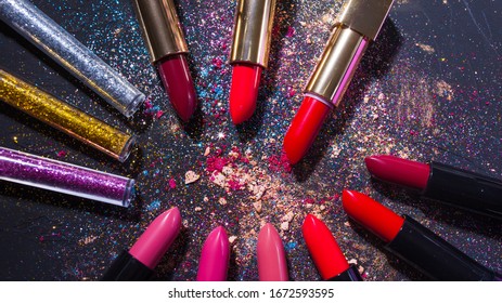 Cosmetics And Beauty Industry, A Set Of Lipsticks On A Background Of Loose Powder And Eye Shadow, Glitter And Sequins For Makeup