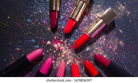 Cosmetics And Beauty Industry, A Set Of Lipsticks On A Background Of Loose Powder And Eye Shadow, Glitter And Sequins For Makeup