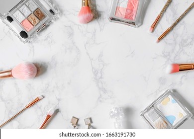 Cosmetics Composition. Pink Brush Set, Blush On, Earring And Eyeshadow Palette On Marble Table. Cosmetic Table For Women Make Up Concept. Cosmetic Products. Flat Lay, Top View. Copy Space.