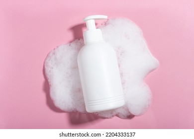 Cosmetics for face, body and hair care. Moisturizer, shampoo or facial cleanser on pink background with foam - Shutterstock ID 2204333137