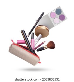 cosmetics flying out of a cosmetic bag on a white background