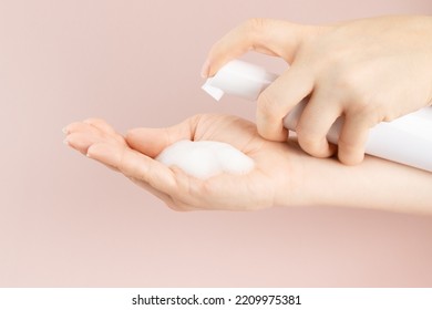 Cosmetics Foam Pump Container, Facewash Dispenser In A Woman's Hand