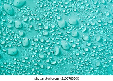 Cosmetics moisturizing liquid drops on a green and blue pastel background. Hyaluronic acid, toner or lotion