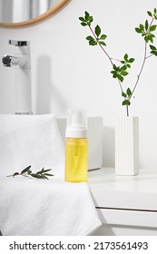 Cosmetics product and cotton towels, cottons pad with green plant on white table inside a bathroom background ceramic. - Shutterstock ID 2173561493