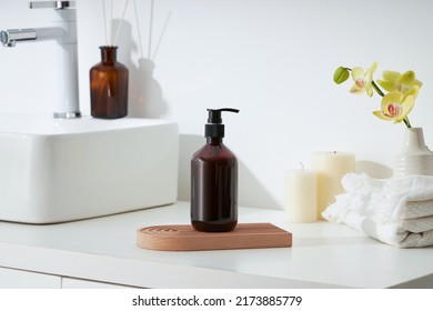 Cosmetics product and cotton towels, cottons pad with green plant on white table inside a bathroom background ceramic. - Shutterstock ID 2173885779