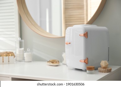 Cosmetics Refrigerator And Skin Care Products On White Vanity Table Indoors