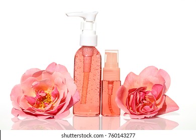 Cosmetics with rose extract. gel and tonic pink color with rose extract in a transparent plastic bottle and terry big pink flower rose . Botanical natural cosmetics concept. 