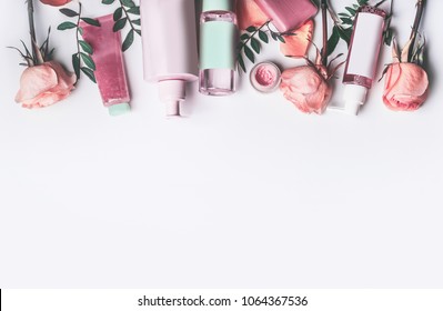 Cosmetics set with Rose essential oils: toner,serum, essence,moisturizer and and others on white desktop background, top view, border. Facial Skin care beauty treatment  - Shutterstock ID 1064367536