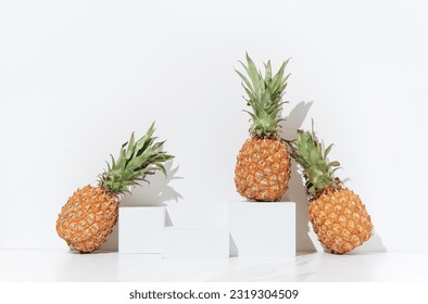 Cosmetics skin care product presentation scene made with empty white podiums and juicy pineapples. Studio photography. - Powered by Shutterstock