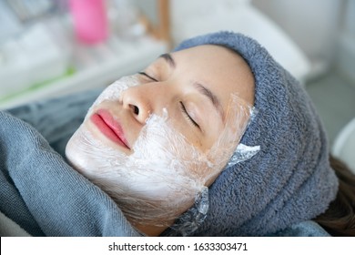 Cosmetologist Applying Anesthetic Cream On Woman Face Before Laser Or Injections.