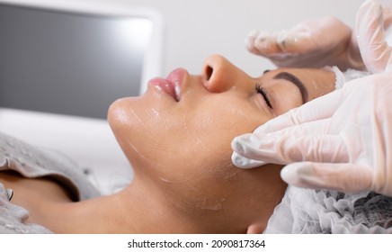 Cosmetologist Applying Cream Essence Essential Vitamins Into Face To Improve Client Skin. Beauty Expert Makes Beauty Treatment For Patient. Health, Skin Care, Aesthetic Medicine Concept.