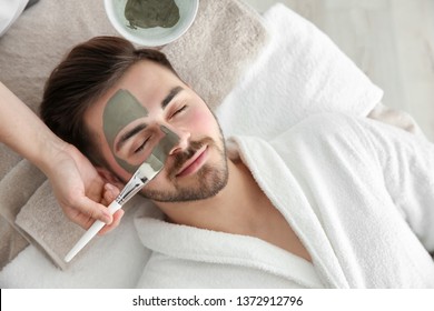 Cosmetologist applying mask on client's face in spa salon, above view - Shutterstock ID 1372912796