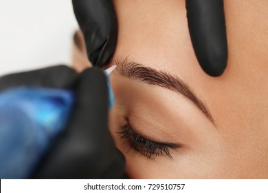 Cosmetologist Applying Permanent Make Up On Eyebrows- Eyebrow Tattoo