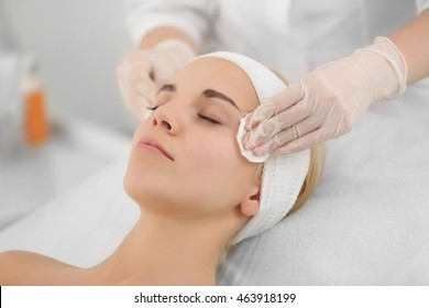 Cosmetologist Cleaning Woman's Face