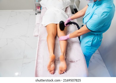 Cosmetologist does a laser hair removal procedure on woman's legs. Close up of feet. Top view. The concept of epilation and professional care in beauty salon. - Shutterstock ID 2169507825