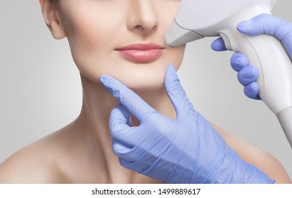 The Cosmetologist Does The Procedure For Laser Hair Removal Of Unwanted Hair Of The Face To A Young Girl In A Beauty Salon.