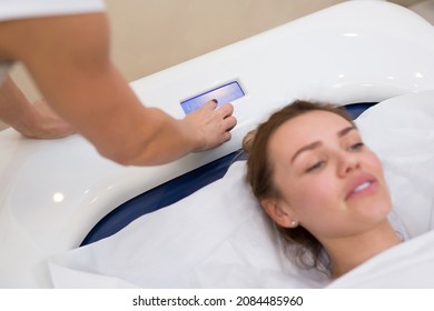 Cosmetologist launches hydromassage in the Spa. Professional modern cosmetology. Body care. The process of the hydromassage bath in the cosmetology clinic.