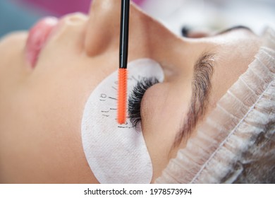 Cosmetologist making eyelash extention and correction using brush - Shutterstock ID 1978573994