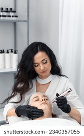 cosmetologist making mesotherapy injection with dermapen on face for rejuvenation. Anti-aging treatment and face lift in cosmetology clinic. medical procedure with Electric pen for derma stamp