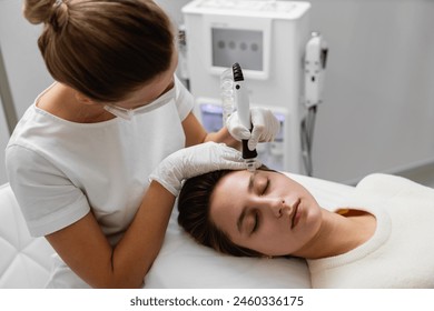 A cosmetologist performs hydropiling in a beauty salon. Skin care. High quality photo - Powered by Shutterstock