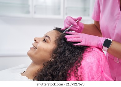 Cosmetologist Performs Mesotherapy Procedure On The Scalp Of A Patient