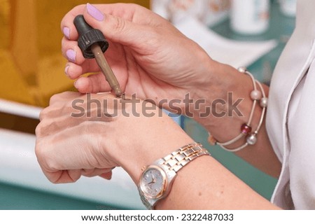 A cosmetologist performs permanent makeup. Checking the pigment on the skin.