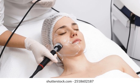 A cosmetologist performs RF lifting and ultrasound facial tightening in a modern salon. This advanced treatment rejuvenates and firms skin, perfect for showcasing effective beauty solutions. - Powered by Shutterstock