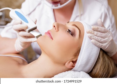 cosmetology and beauty concept - beautiful woman receiving ultrasound cavitation facial peeling procedure
