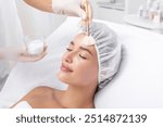 Cosmetology beauty procedures. Lady receiving rejuvenation treatment, facial chemical peel therapy in beauty salon or medical center