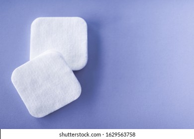 Cosmetology, cleanliness and branding concept - Organic cotton pads on purple background, cosmetics and make-up remover, hygiene and skincare beauty brand product for healthcare and medical design