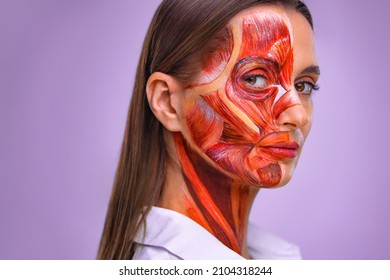 Cosmetology concept. Young woman with half of face with muscles structure under skin. Model for medical training on a light background. Close up photo of face human anantomy. - Shutterstock ID 2104318244