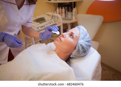 Cosmetology the doctor makes an injection syringe on his face - Shutterstock ID 682460476