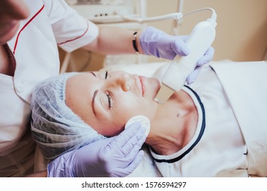Cosmetology doctor makes the procedure a woman face cleaning - Shutterstock ID 1576594297