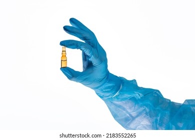 Cosmetology And Skin Care. Beautician's Hand In A Blue Medical Glove With An Ampoule. Elixir Of Youth Or Anti-relic Serum, Skin Hydration, Revitalization