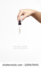 Cosmetology and skincare concept. Close up of beautiful female hand holding the pipette of a dropper. Vertical format isolated on white background with copy space - Shutterstock ID 2209676941