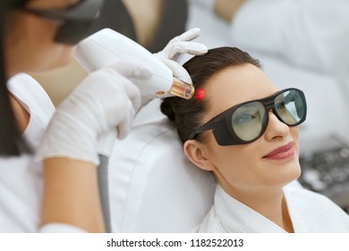 Cosmetology. Woman At Hair Growth Laser Stimulation Treatment