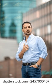 Cosmopolitan handsome man posing at camera in the city
