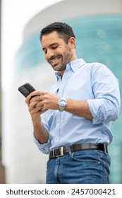 Cosmopolitan handsome man using mobile device