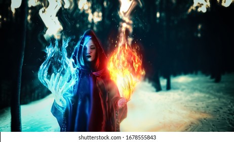 Cosplay, fantastic, artistic photo processing. A girl in a black robe, from her hands comes a fire of 
turquoise and dark yellow and red. Dark magic forest.