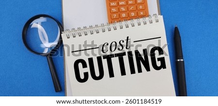 Cost Cutting Strategy – Notebook with ‘Cost Cutting’ Text, Office Supplies, and Calculator on Desk – Budget Planning, Expense Reduction, and Financial Management Concept. 