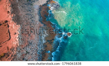 Aerial Drone View Of Dramatic Ocean Waves Crushing On Rocky Landscape