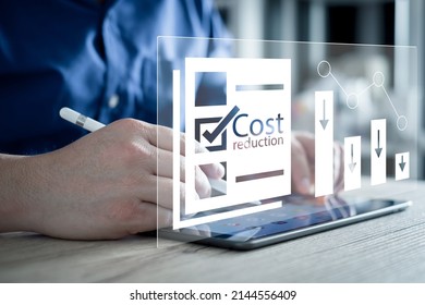 Cost reduction Concept. Businessman with his hand lowers the arrow of the graph. Cost text with a down arrow. budget, Cost Management. cut, lower. - Shutterstock ID 2144556409