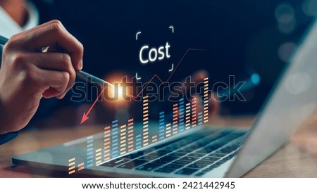 Cost reduction concept. Businesswoman pointing down arrow of the graph with cost reduction business finance on virtual screen. Business, technology, cost management, cut budget.