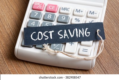 Cost Saving Words Written On Label With Calculator,Business Concept